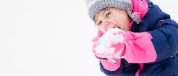 Little girl eats snow Little girl eats snow