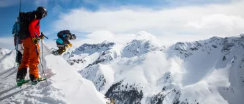 skiers drop in from a cliff in Silverton, Colorado