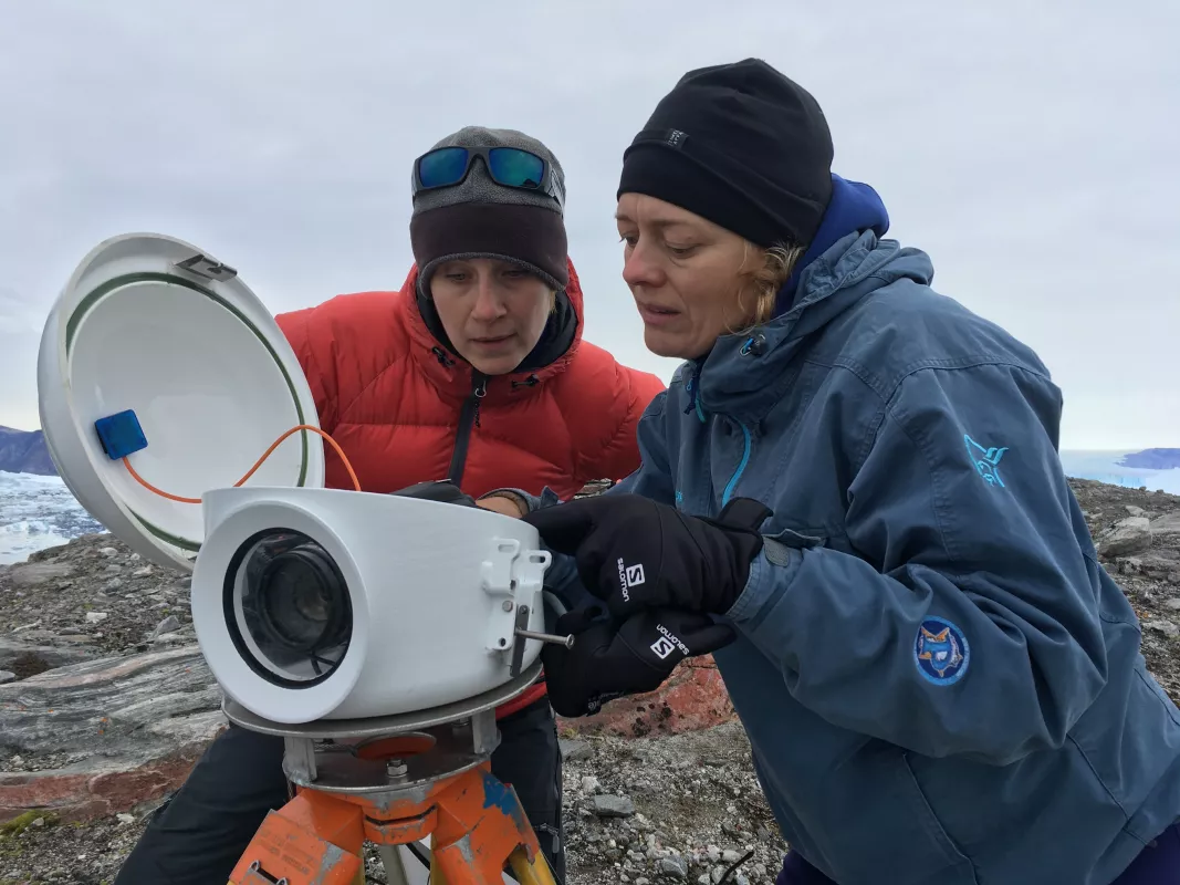 researchers Laidre and Simon check camera equipment off coast of Greenland