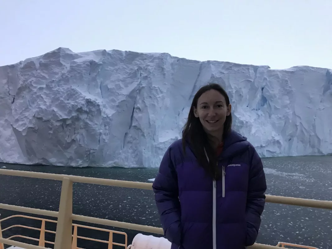 Tasha Snow stands in front of the Thwaites ice shelf. 