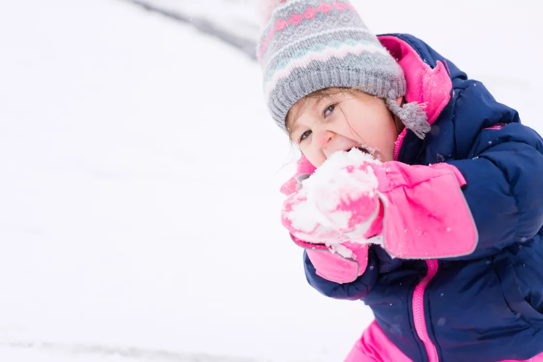 Little girl eats snow