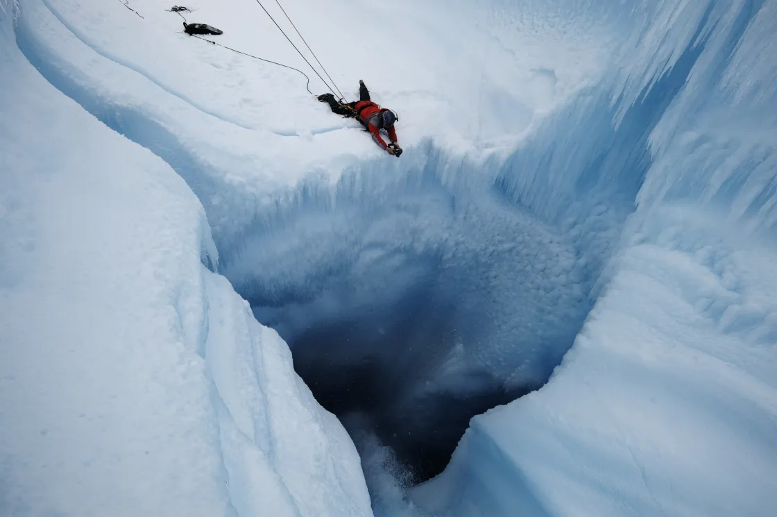 James Balog points his camera down into a moulin to capture melt on the Greenland Ice Sheet. 