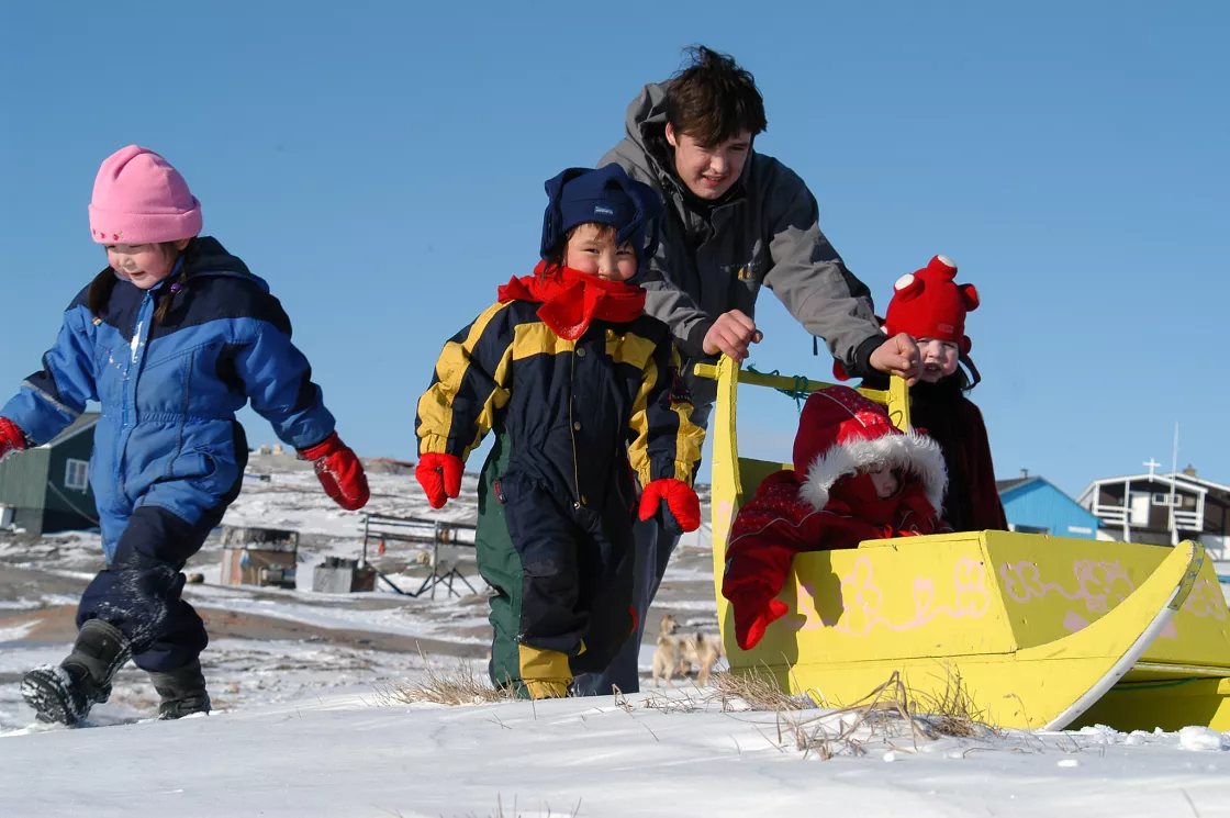 Children bundled up in snowsuits in Greenland