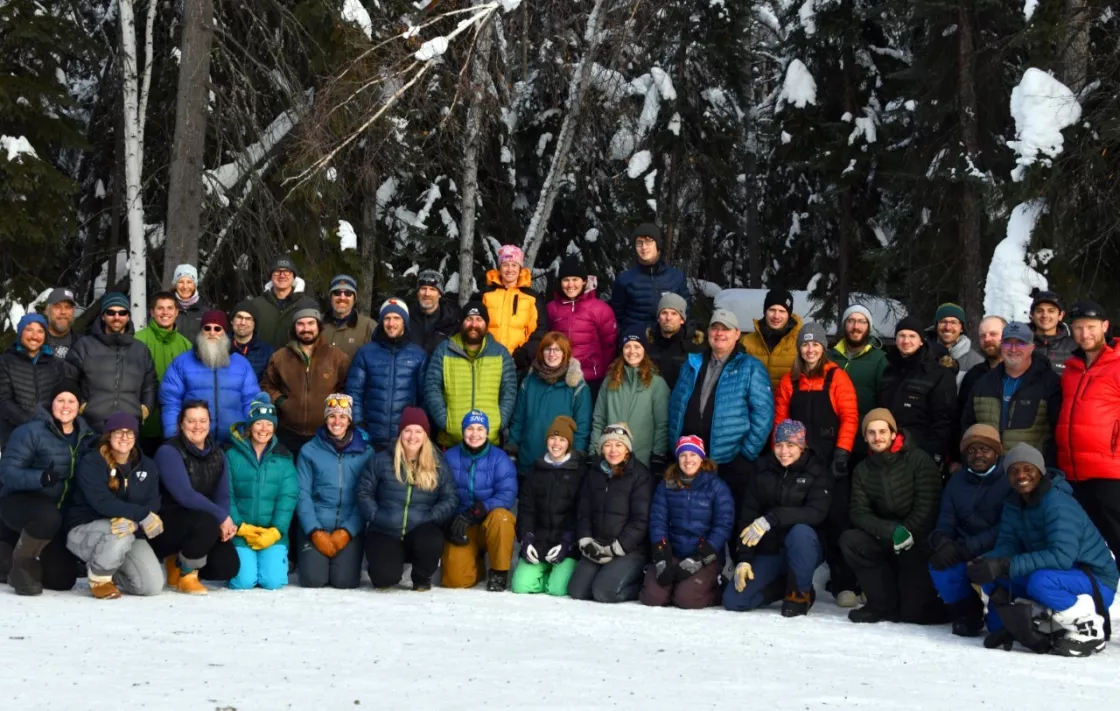 The SnowEx March 2023 field staff huddles together for a photo. 