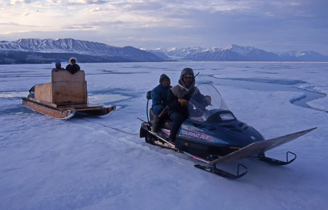 Inuit family on snowmobile in Canada