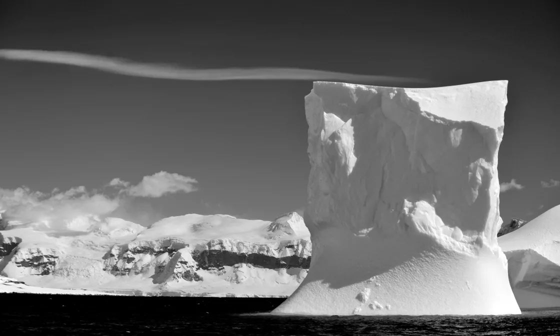 A grounded iceberg rests in front of the Antarctic Peninsula