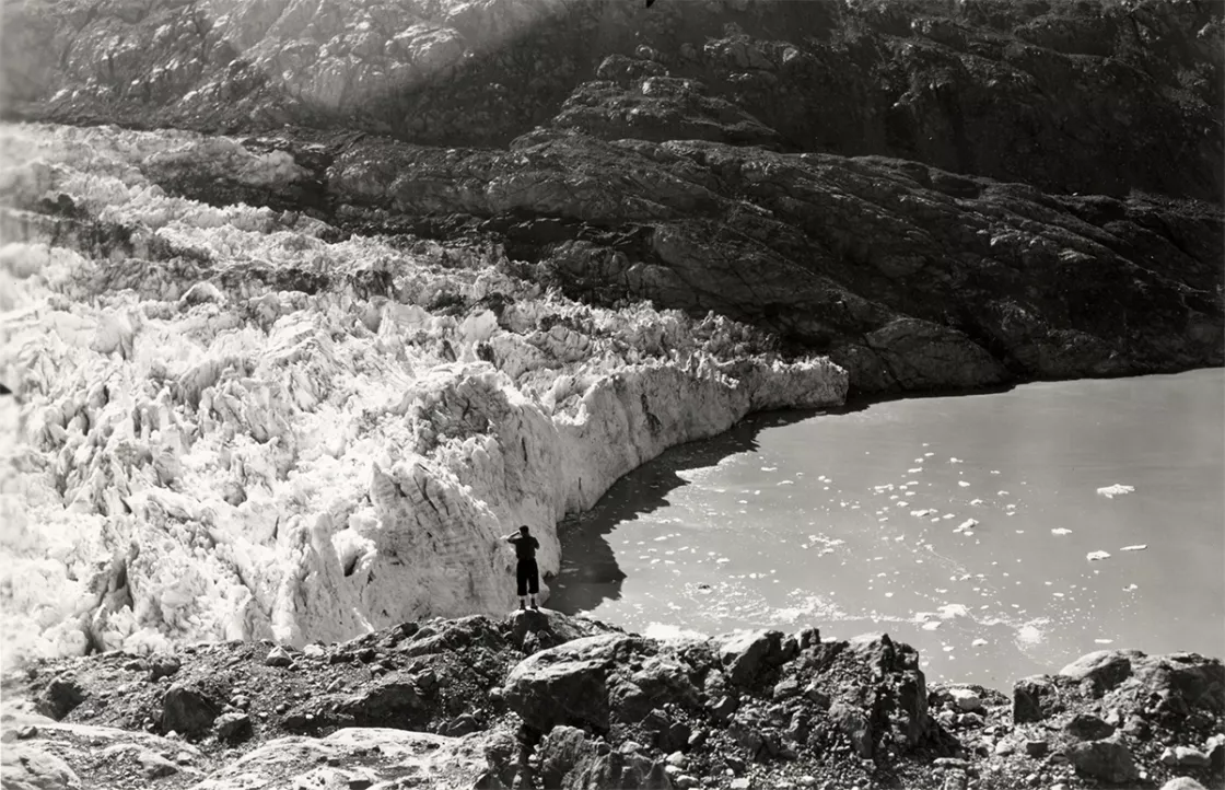 Man stands looking out at Lamplugh Glacier