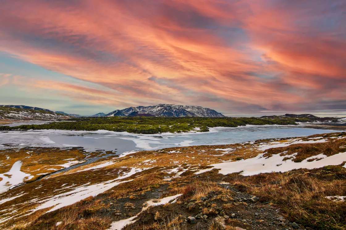 A colorful sunset lights up a tundra landscape