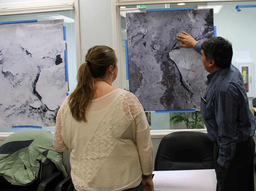 Lewis Brower, Sea Ice expert from Barrow, Alaska, shares his knowledge with Rebecca Legatt from the National Weather Service's Anchorage Ice Desk. Combining knowledge, expertise, and data can greatly enhance the understanding of sea ice. Credit: P. Pulsifer