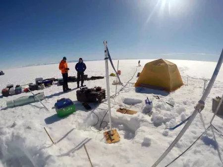 Researchers conducting an aquifer test on the Greenland ice sheet.