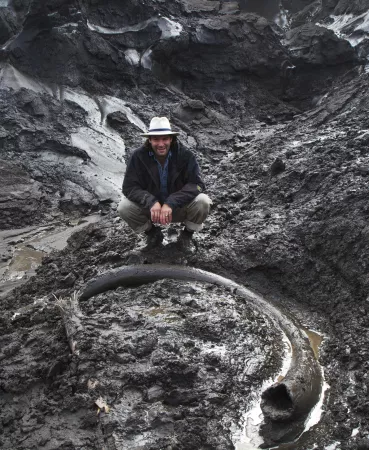a frozen mammoth tusk in thawing permafrost