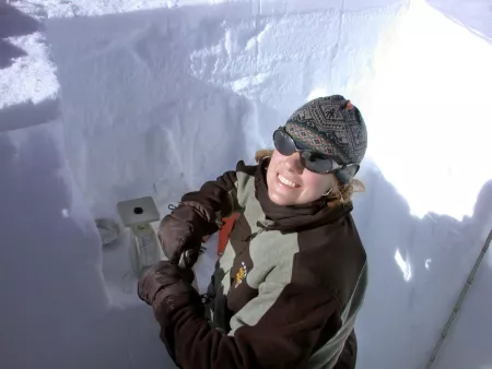 Scientist takes samples of snow in snow pit
