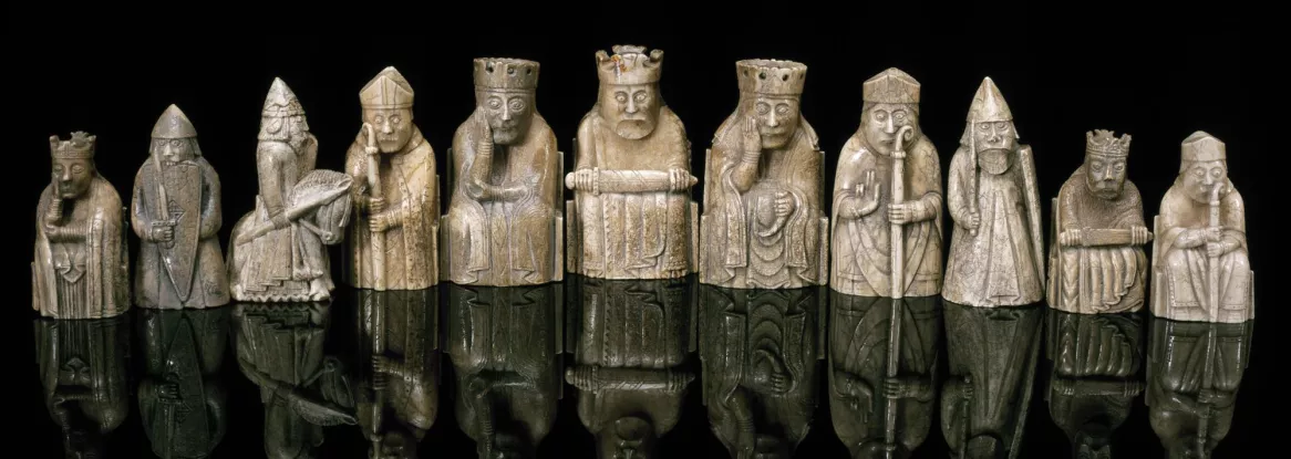 Lewis Chessmen with reflection on black surface