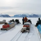 The project team traveling by skidoo and qamutiik (sled) to visit weather stations. Esa often hunts along the way, successfully catching seals on this outing (seen on the back of the sled). These trips are learning experiences for the team in more ways than just weather. 