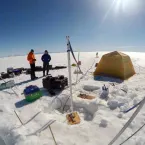 Researchers conducting an aquifer test on the Greenland ice sheet.