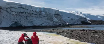 Dr. Alia Khan and colleague Edgardo Sepulveda collect spectra albedo measurements in front of Collins Glacier on King George Island. Credit: Gonzalo Barrera