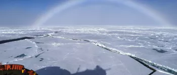 A fog bow forms over sea ice in the Arctic.